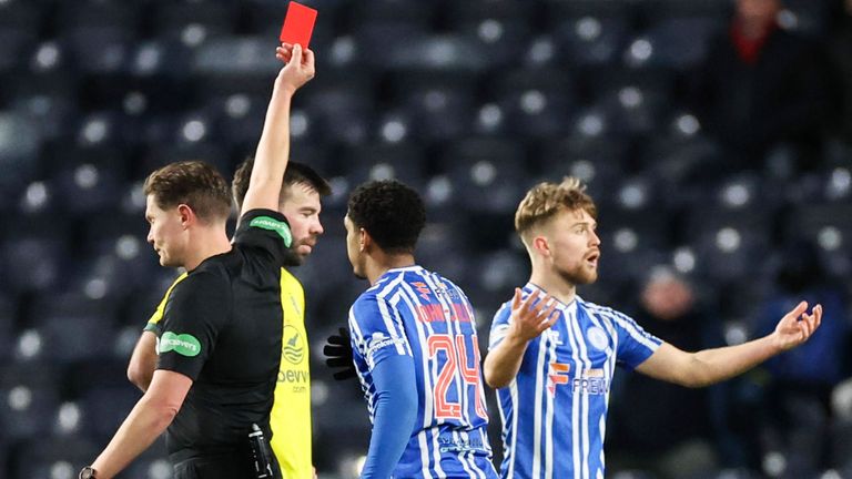Referee David Dickinson shows Kilmarnock's David Watson a red card