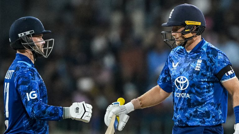 England's Ben Duckett (L) and Joe Root bump their fists during the first one-day international cricket match between Sri Lanka England