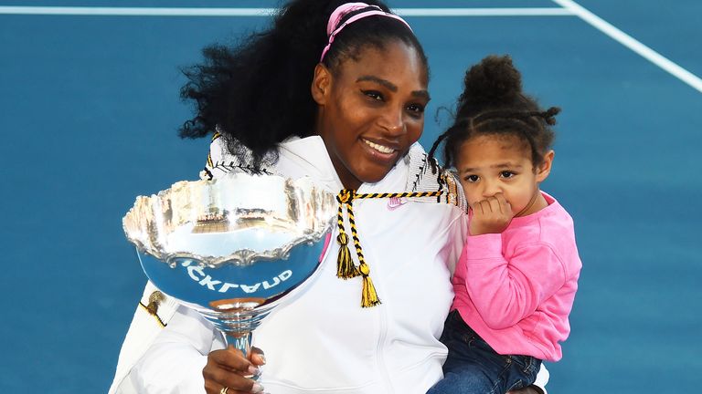 Serena Williams holds her daughter and the ASB trophy after winning her singles finals match in 2020
