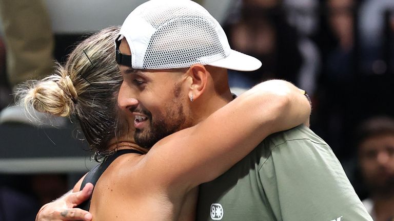 Nick Kyrgios and Aryna Sabalenka embrace at the net at the end of their Battle of the Sexes match, in Dubai, United Arab Emirates