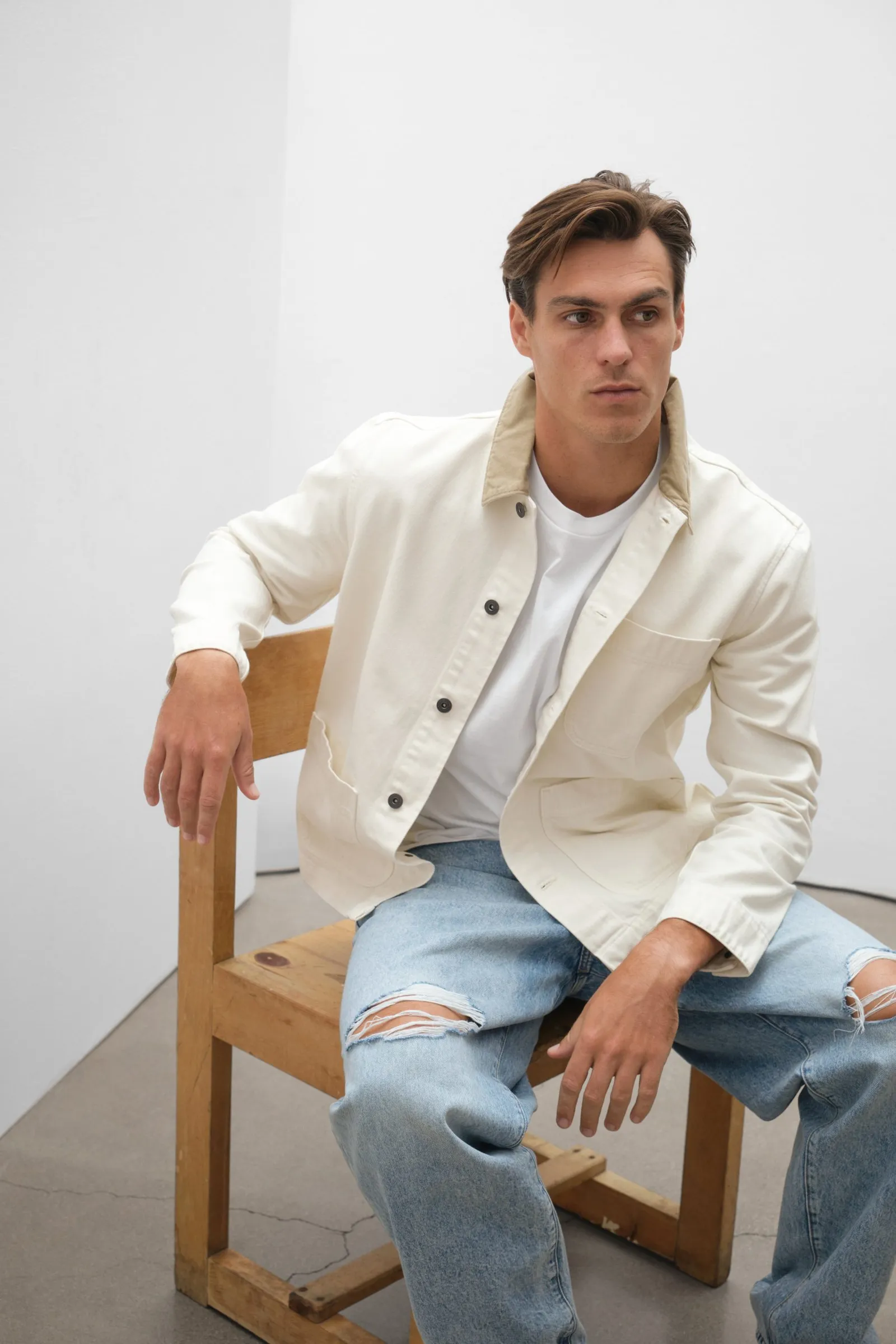 Image may contain Clothing Pants Person Sitting Plywood Wood Adult Shirt and Furniture