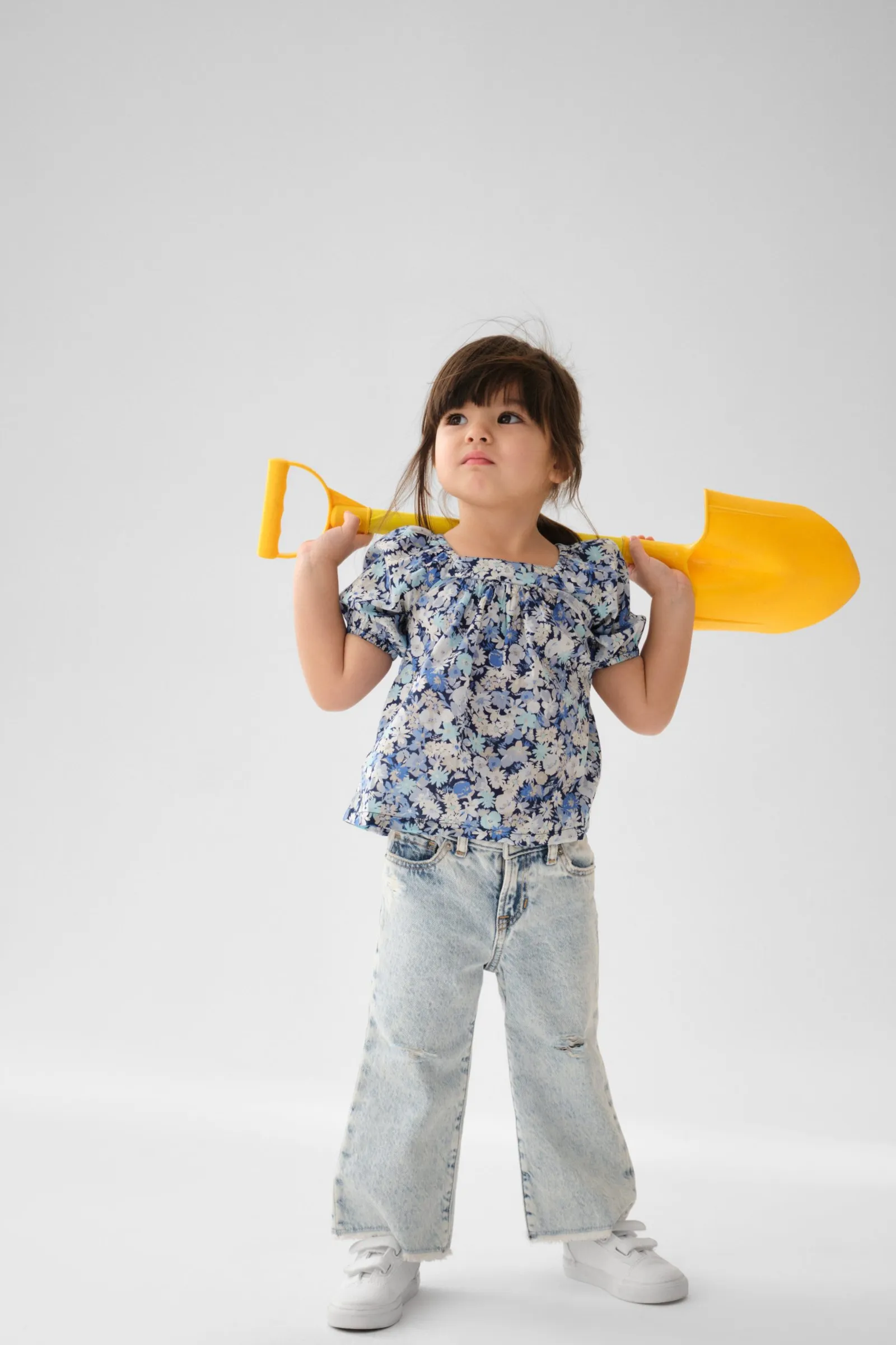 Image may contain Clothing Pants Face Head Person Photography Portrait Child Footwear Shoe Device and Shovel