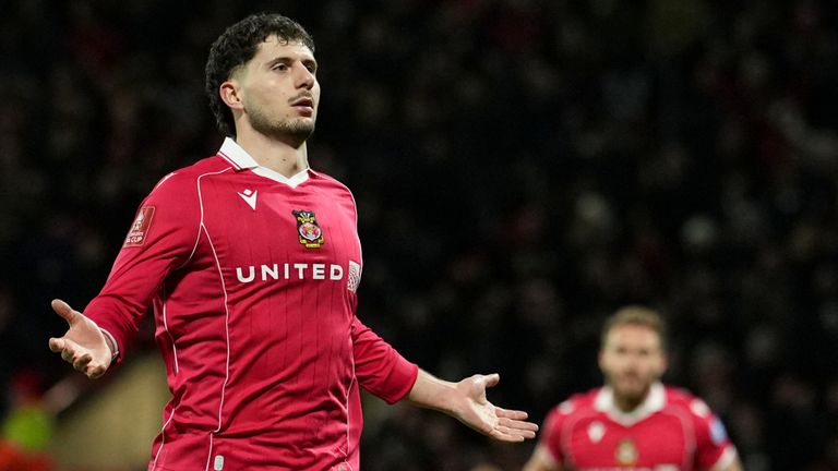 Wrexham's Liberato Cacace celebrates after scoring the opening goal during the English FA Cup third round soccer match between Wrexham and Nottingham Forest in Wrexham, Wales, Friday, Jan. 9, 2026. (AP Photo/Jon Super)