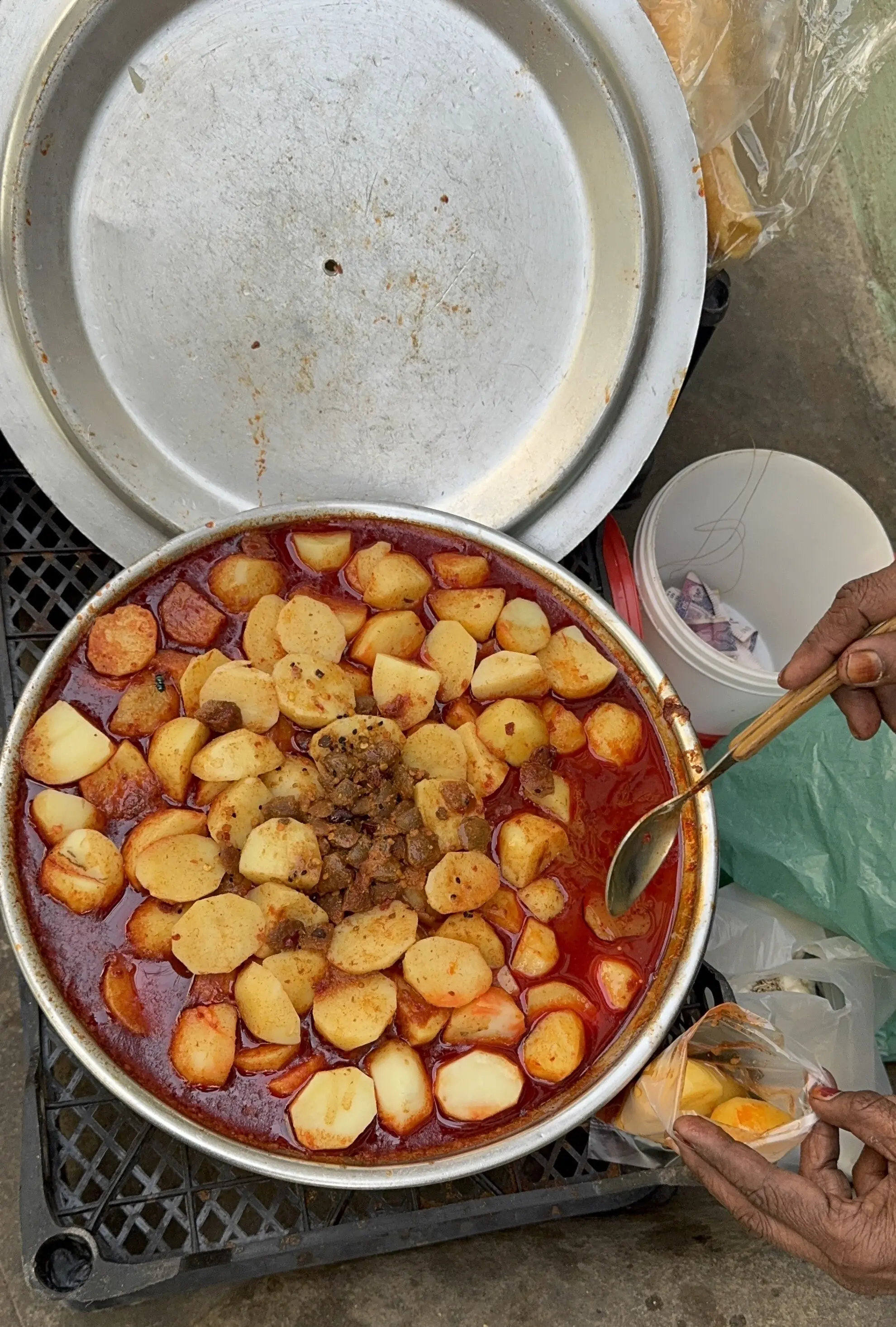 A woman sells food on a street corner in Lyari.