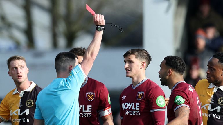 Referee Lewis Smith shows a red card to West Ham's Freddie Potts
