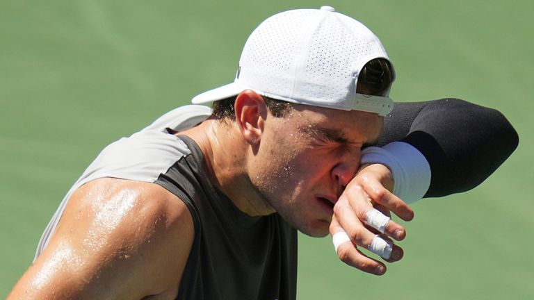 Jack Draper wipes sweat from his face between serves against Federico Agustin Gomez at the US Open