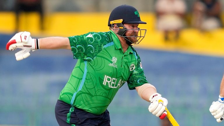 Ireland's captain Paul Stirling, left, winces as he runs with batting partner Ross Adair between the wickets during the T20 World Cup cricket match between Australia and Ireland in Colombo, Sri Lanka, Wednesday, Feb. 11, 2026. (AP Photo/Eranga Jayawardena)