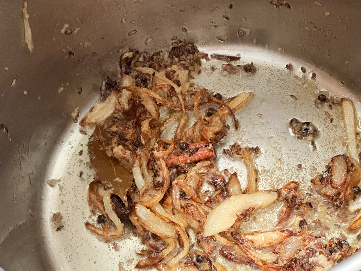 Crushed garlic and ginger folded in to the fried onions and whole spices 