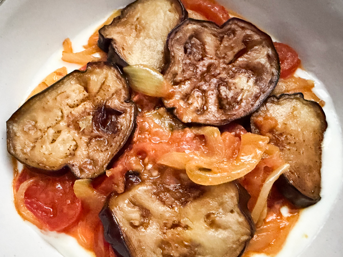 eggplant, tomato and onion curry layered on top of whisked yogurt